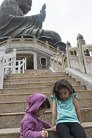 Kids Playing Under The Giant Buddha