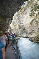 Crowded Walkway Under Stone