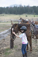 Claira Patting Horse After Ride