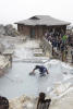 Worker Pulling Black Eggs Out Of Hot Spring