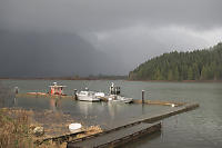 Boats At Dock With Rain In The Distance