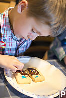 Marcus Putting Sprinkles On Cookie