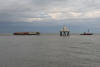 Sandheads Lighhouse With Barge And Tugboat