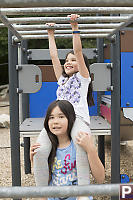 Nara Helping Claira With Monkey Bars