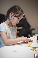 Claira Shaping Stones With Sandpaper