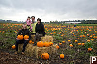 Sitting On Hay Bales In Pumpkin Patch