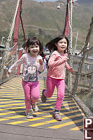 Girls Running On Bridge