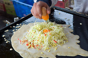 Cracking Eggs Into Okonomiyaki