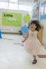 Claira Strolling With Two Balloons