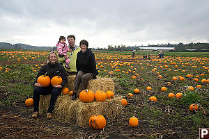 Sitting On Hay Bales In Pumpkin Patch