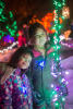 Nara And Claira Around String Of Lights