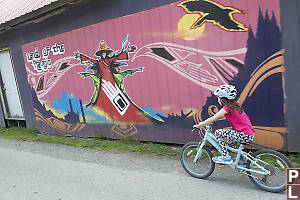 Claira Biking Past Mural